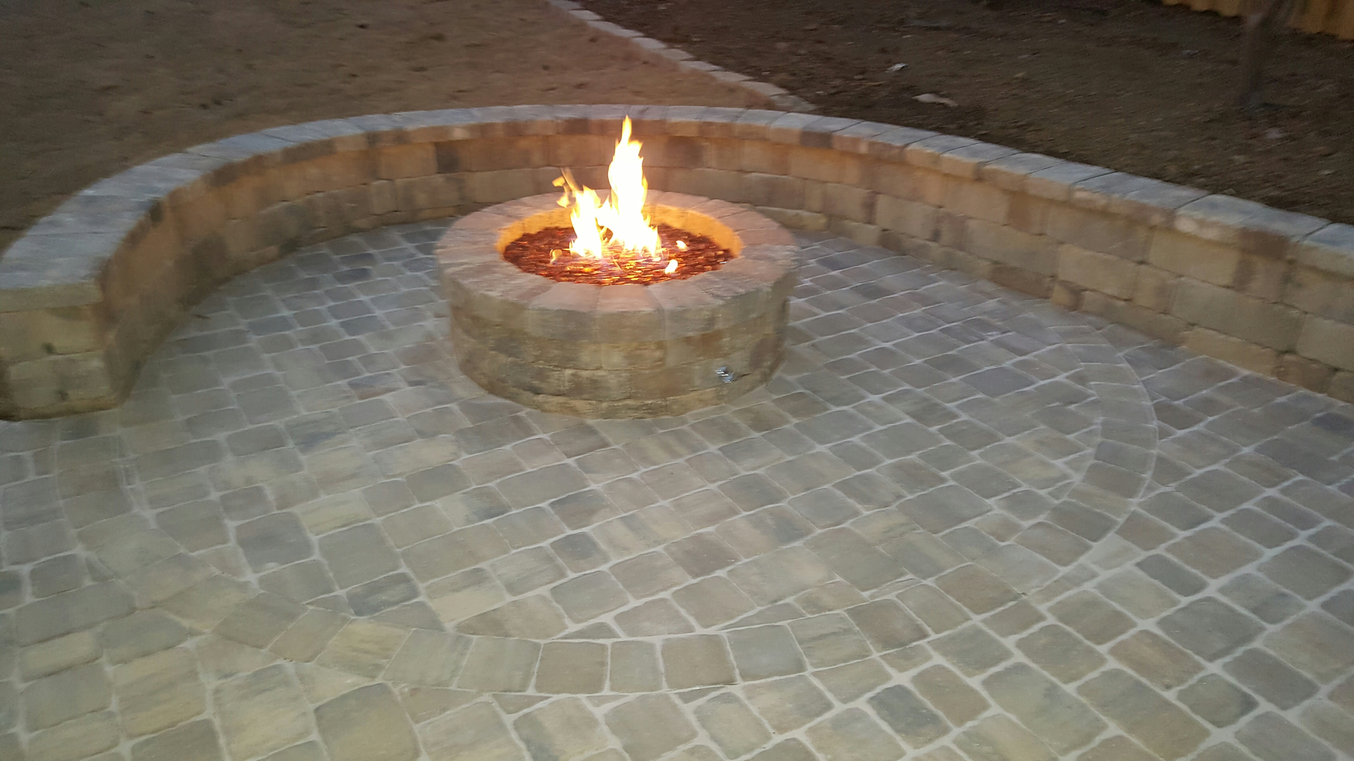 Paver patio with stone sitting wall and fire pit.